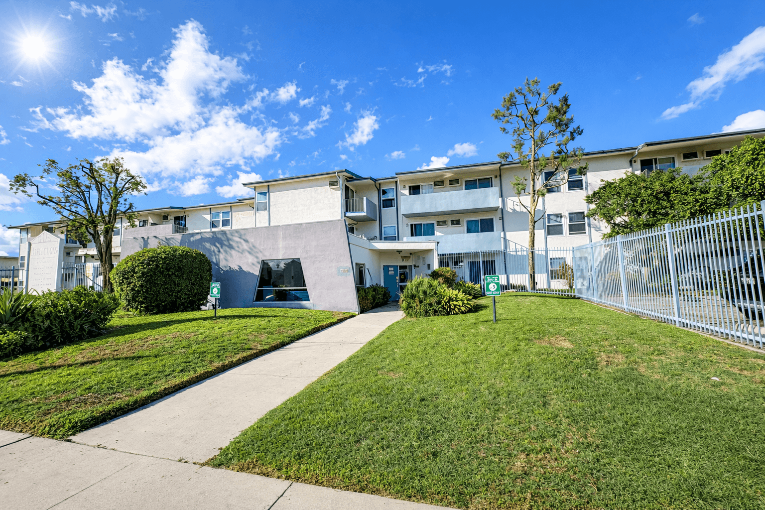 A sunny day at a residential complex with a clear blue sky.